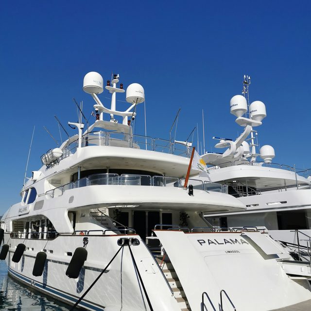 The foredeck and mast head of a large motor yacht at its moorings